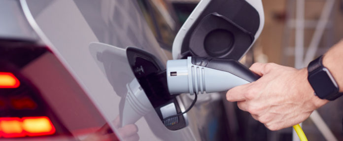 LREM-ev-charge-hand-Shutterstock_1499395205 1047 × 430
